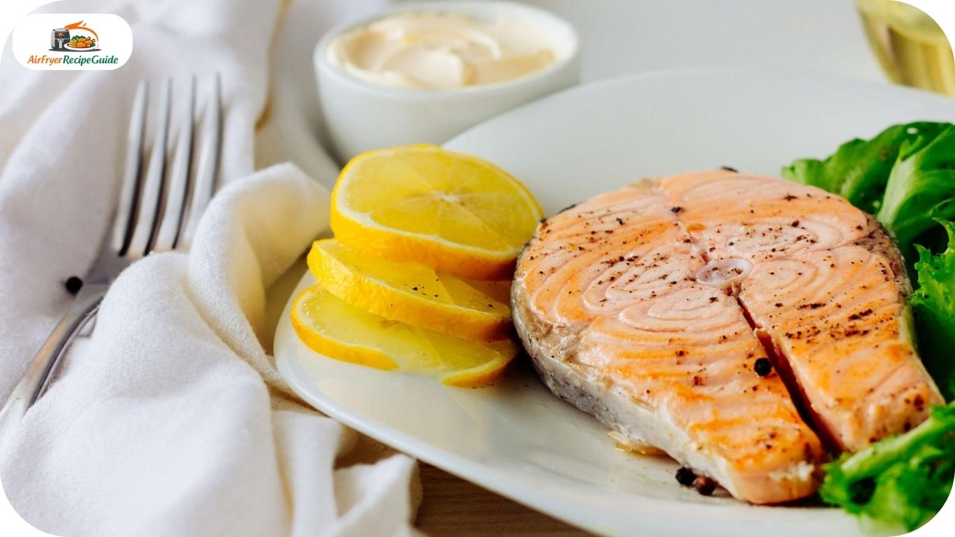 Juicy garlic butter salmon fillets garnished with herbs and lemon