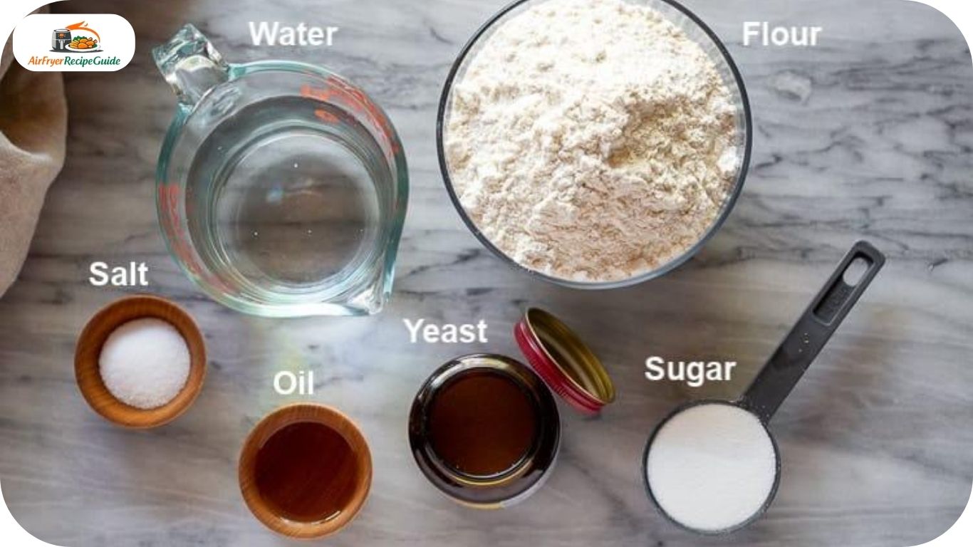 Flour yeast olive oil sugar salt and warm water arranged for homemade bread